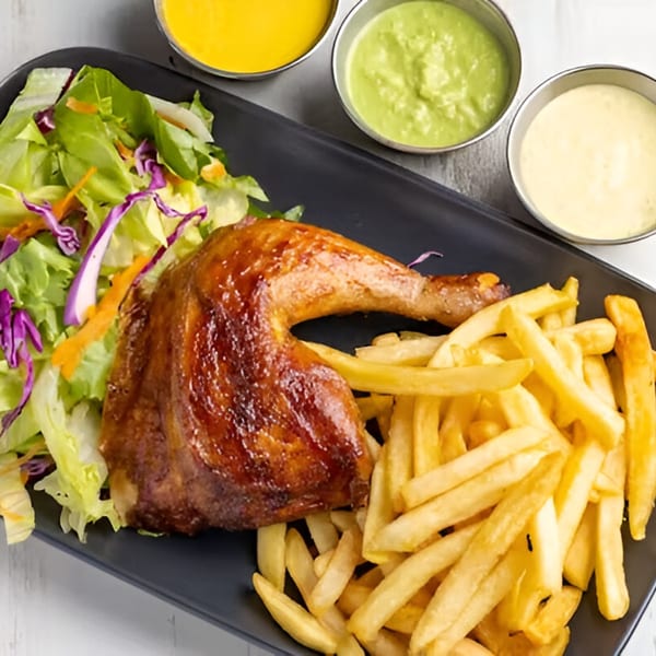 El Pollo Inka Miami's roasted chicken leg with fries, salad, and three dipping sauces.